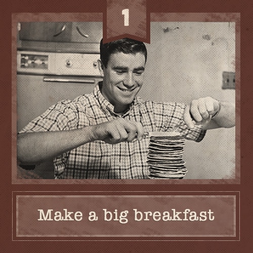 Man eating large stack of pancakes. 