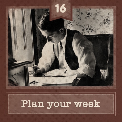 Vintage man sitting at desk writing on papers. 