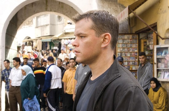 A man is standing in front of a crowd, displaying exceptional situational awareness.