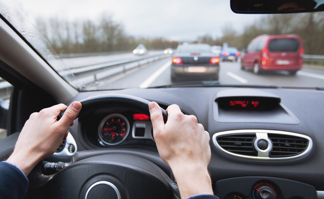 A person practicing defensive driving on a highway.