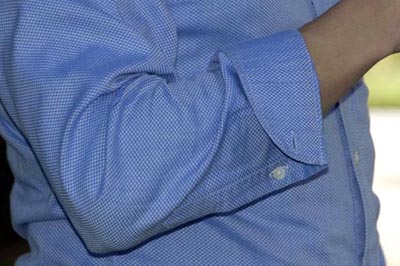 Roll shirt sleeves close up photo arms.