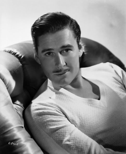 Actor Errol Flynn posing with mustache.