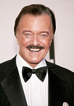 Robert Goulet's smiling portrait showing mustache.