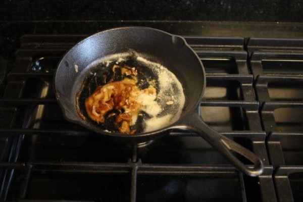 Brown mixture for a smoke bomb in a pan on a stove.