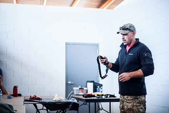 Medic Justin Hurzeler demonstrating how to use a tourniquet.