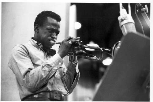 Miles Davis playing trumpet in studio. 