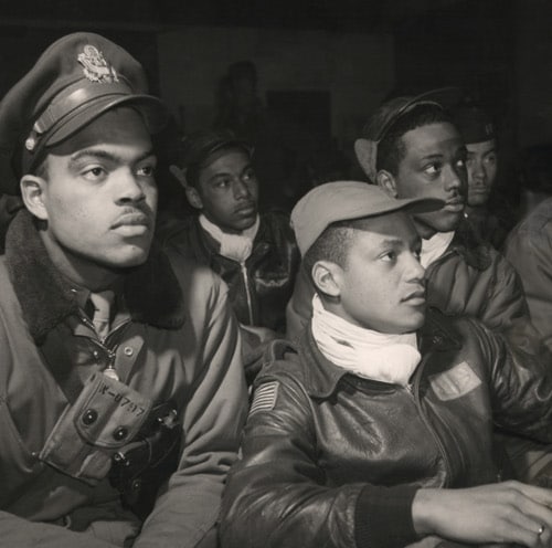 Vintage african american pilots wearing leather jackets and scarfs.