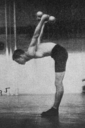 An old photo of a young man lifting weights.