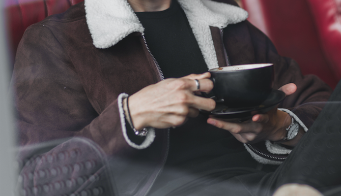 A woman holding a cup of coffee.