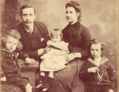 An old photo of a family posing for a picture in 1886.