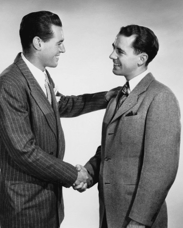 A handshake between two men in a black-and-white photo.